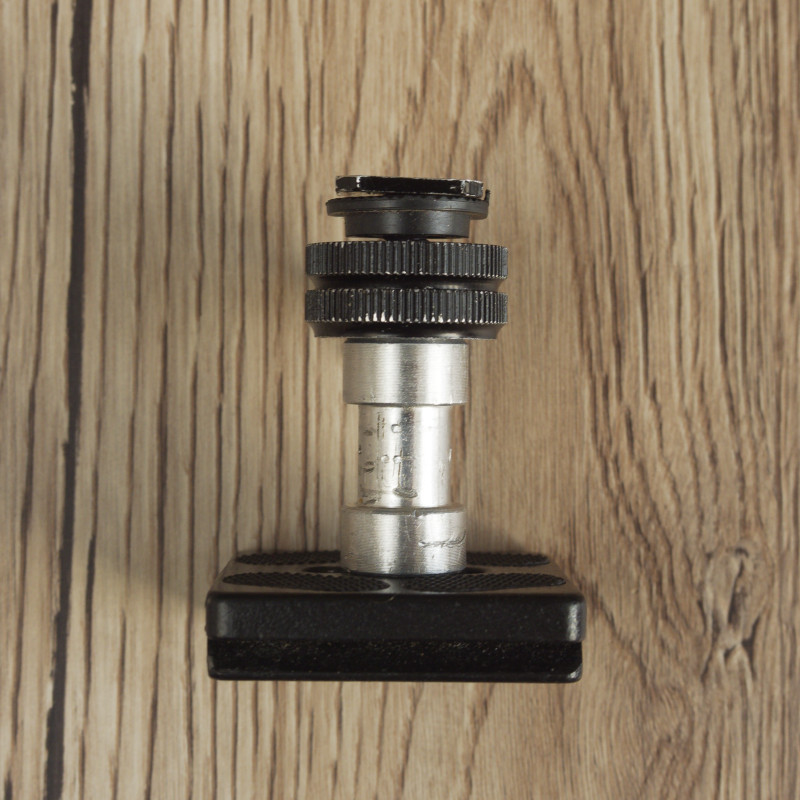 Photo of a home-made bracket to hold a camera in the correct orientation when used on a tripod with the centre column inverted. 